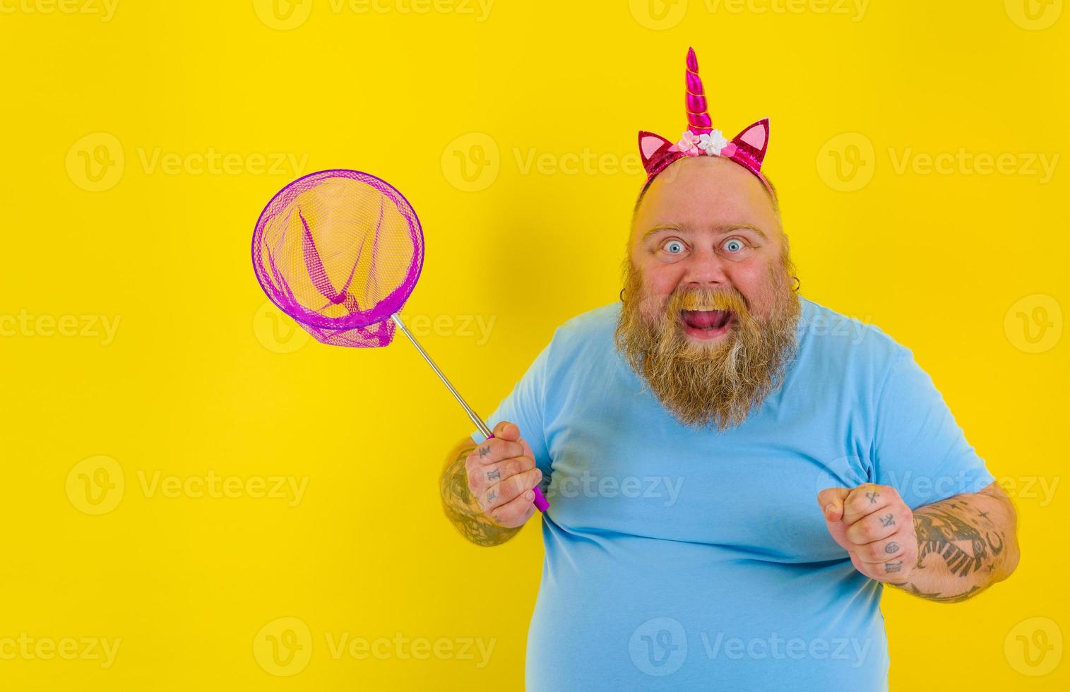 Fat happy man with headband play with sea net photo