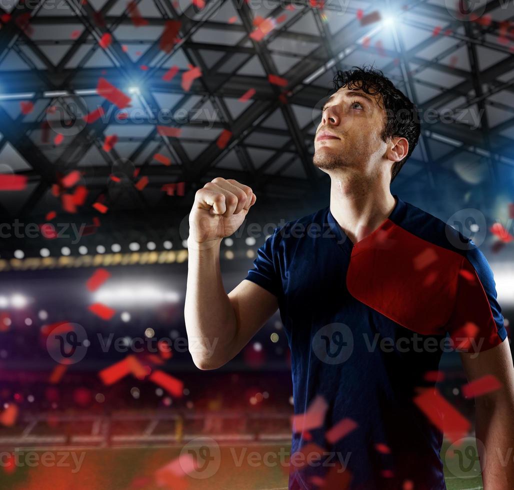 Soccer striker rejoices for the victory at the stadium photo