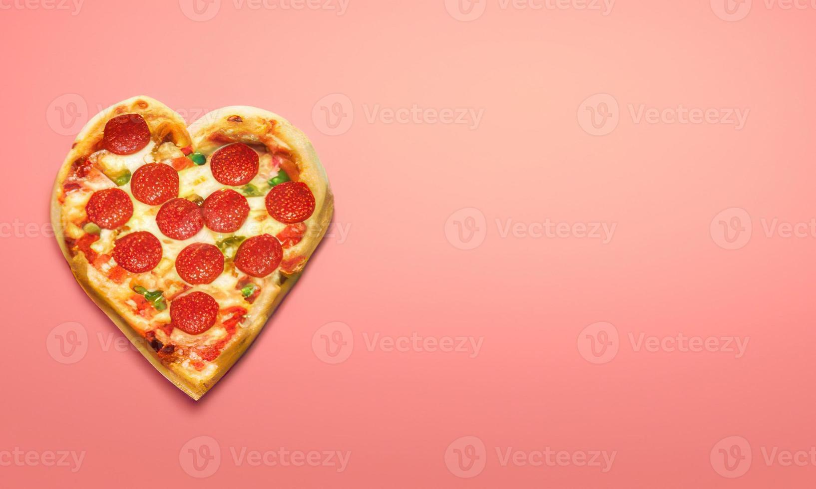 heart shape pizza on plain background photo