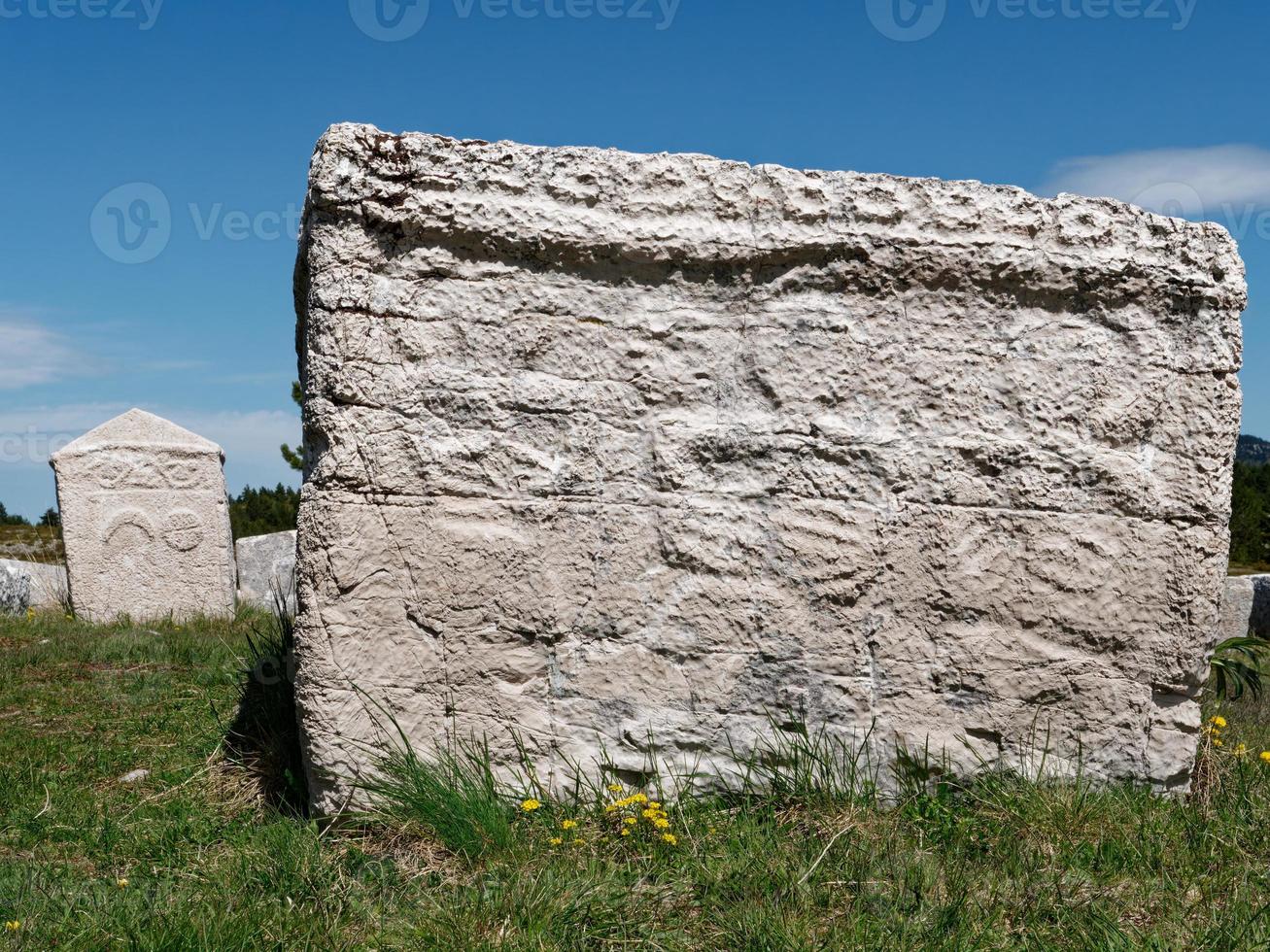 Stecci Medieval Tombstones Graveyards Dugo Polje in Blidinje, BiH. Unesco site. Historic place of interest. The tombstones feature a wide range of decorative motifs and inscriptions. photo