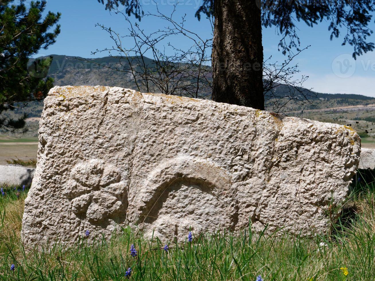 Stecci Medieval Tombstones Graveyards Risovac in Blidinje, BiH. Unesco site. Historic place of interest. The tombstones feature a wide range of decorative motifs and inscriptions. photo
