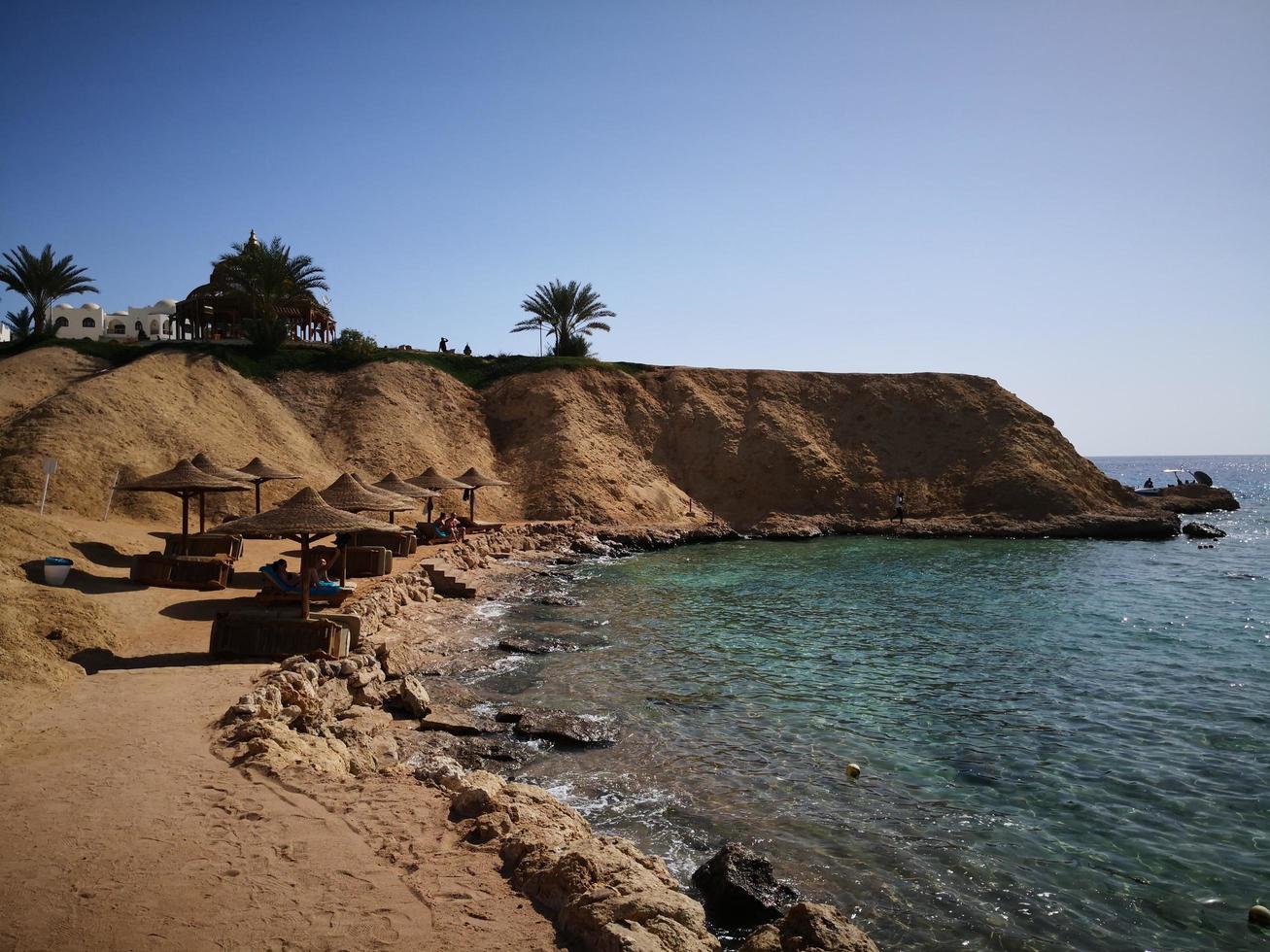 Sea coast, sandy beach, blue sky photo