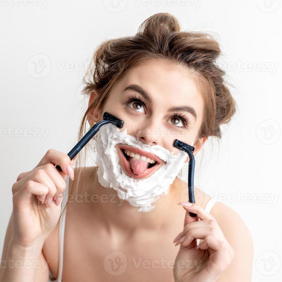 Woman with shaving foam on her face photo