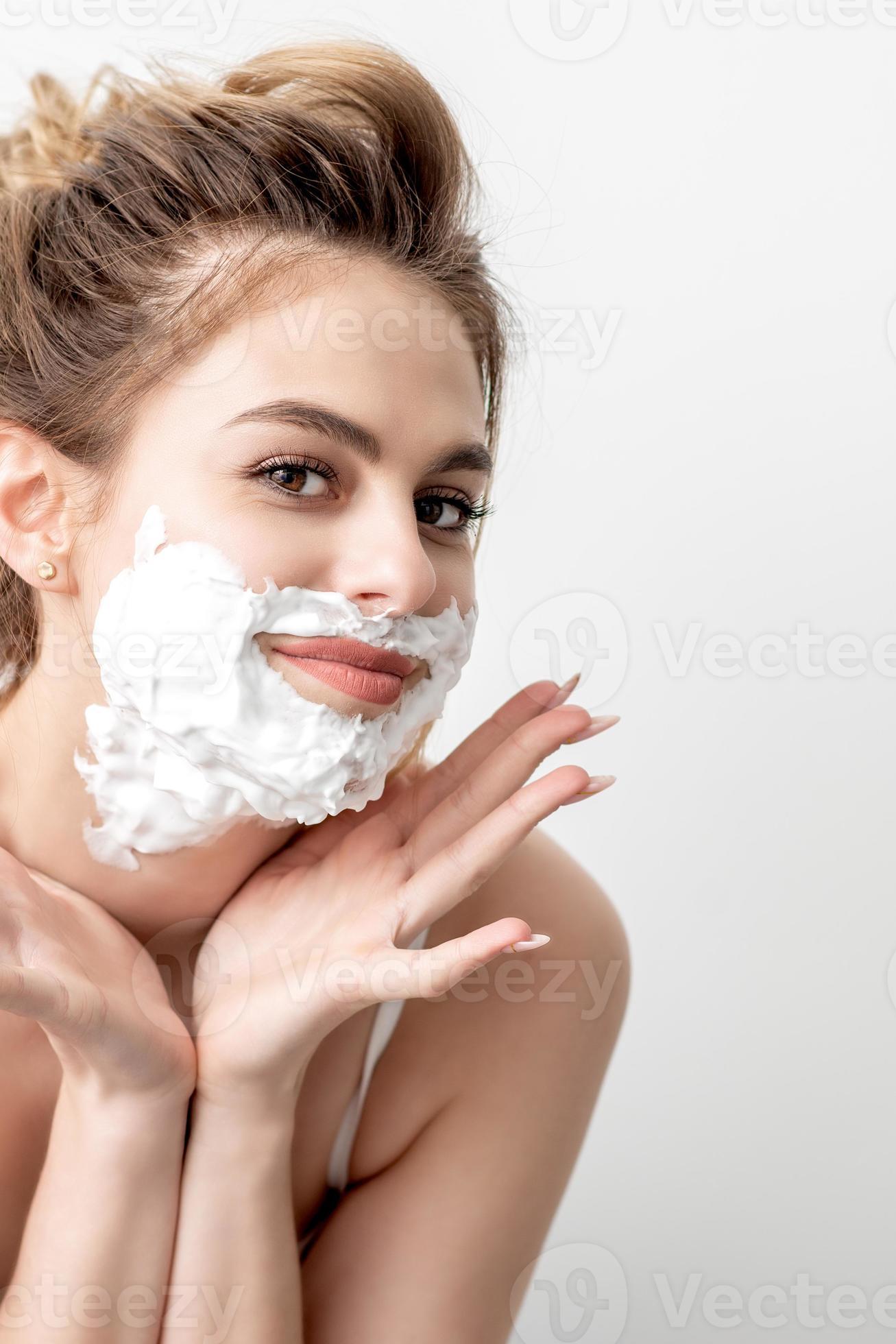 Woman with shaving foam on her face 20569876 Stock Photo at Vecteezy