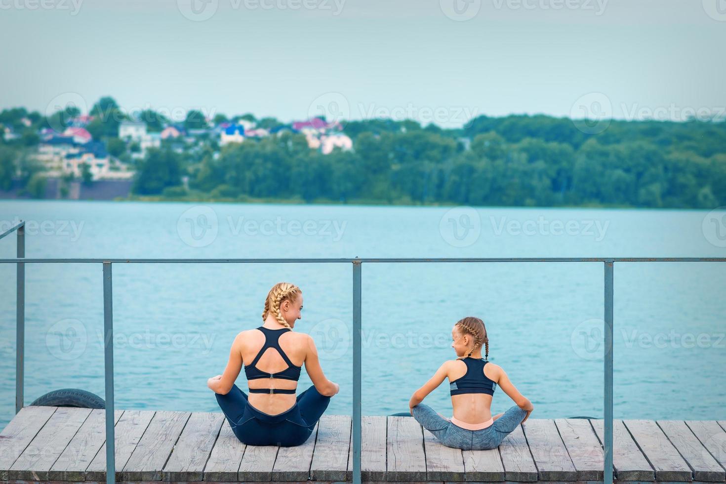Mother and daughter doing gym exercises photo