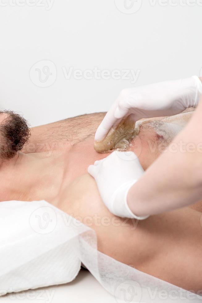 Epilation chest of young male photo