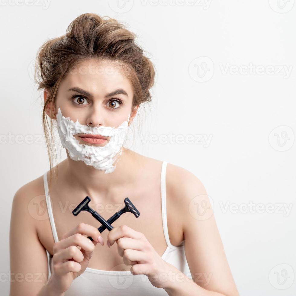 Woman with shaving foam on her face photo