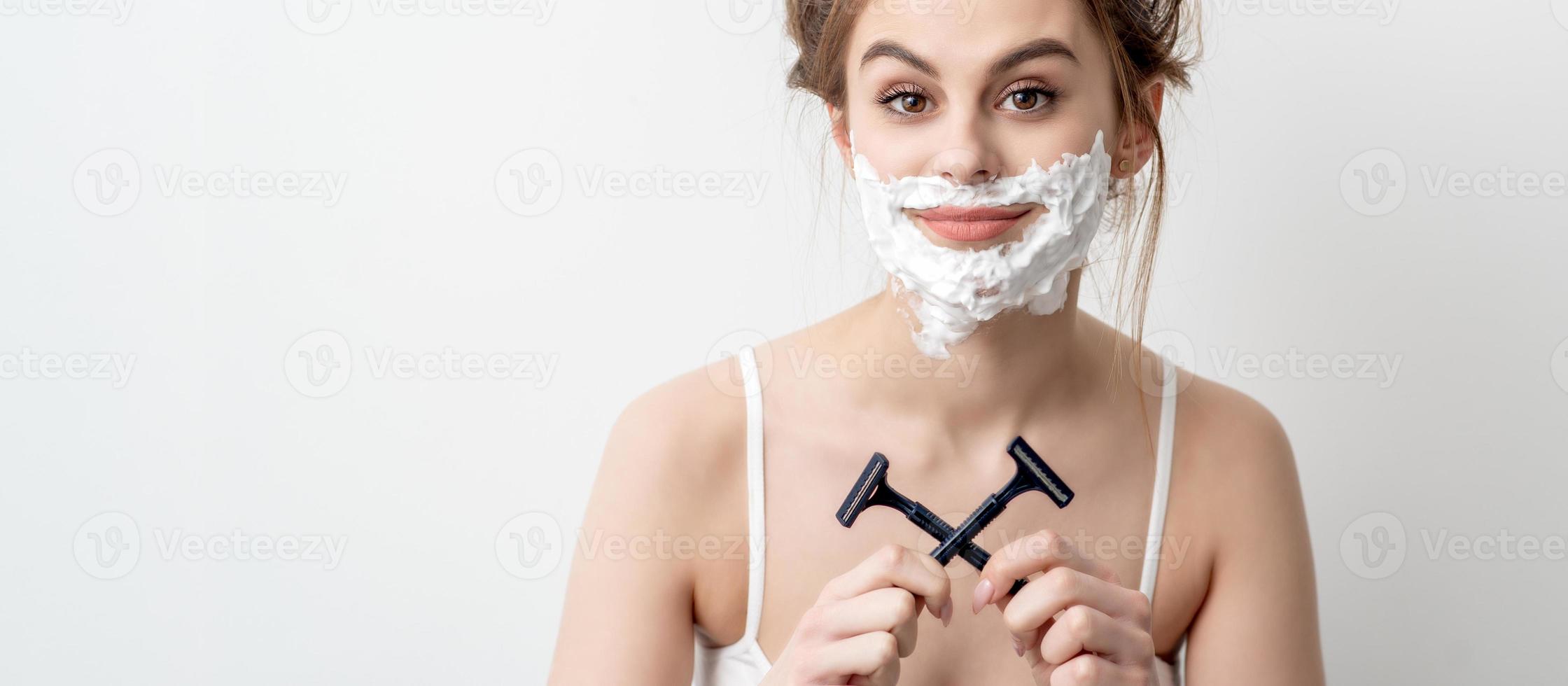 Woman with shaving foam on her face photo