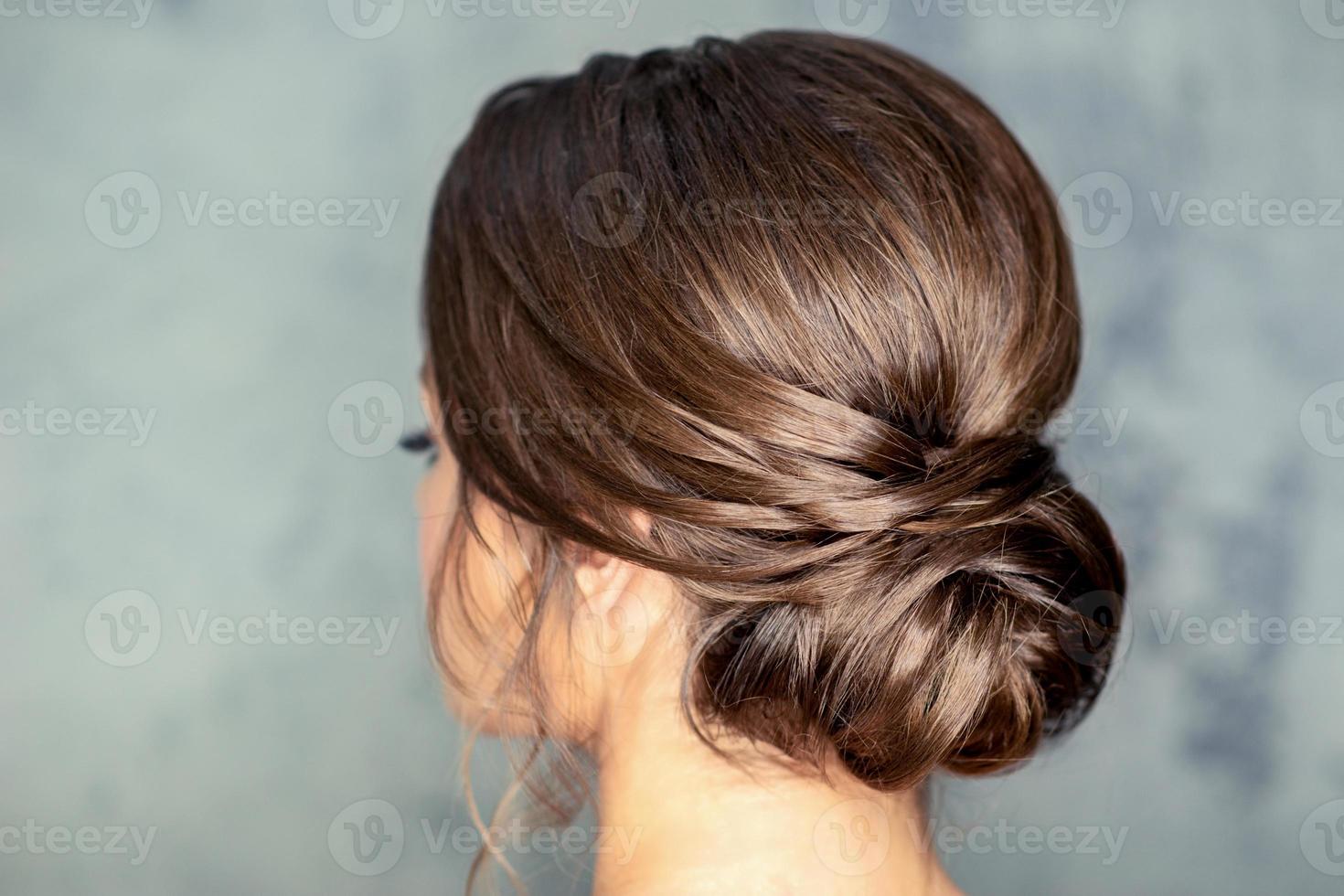 Brunette woman with middle bun hairstyle photo