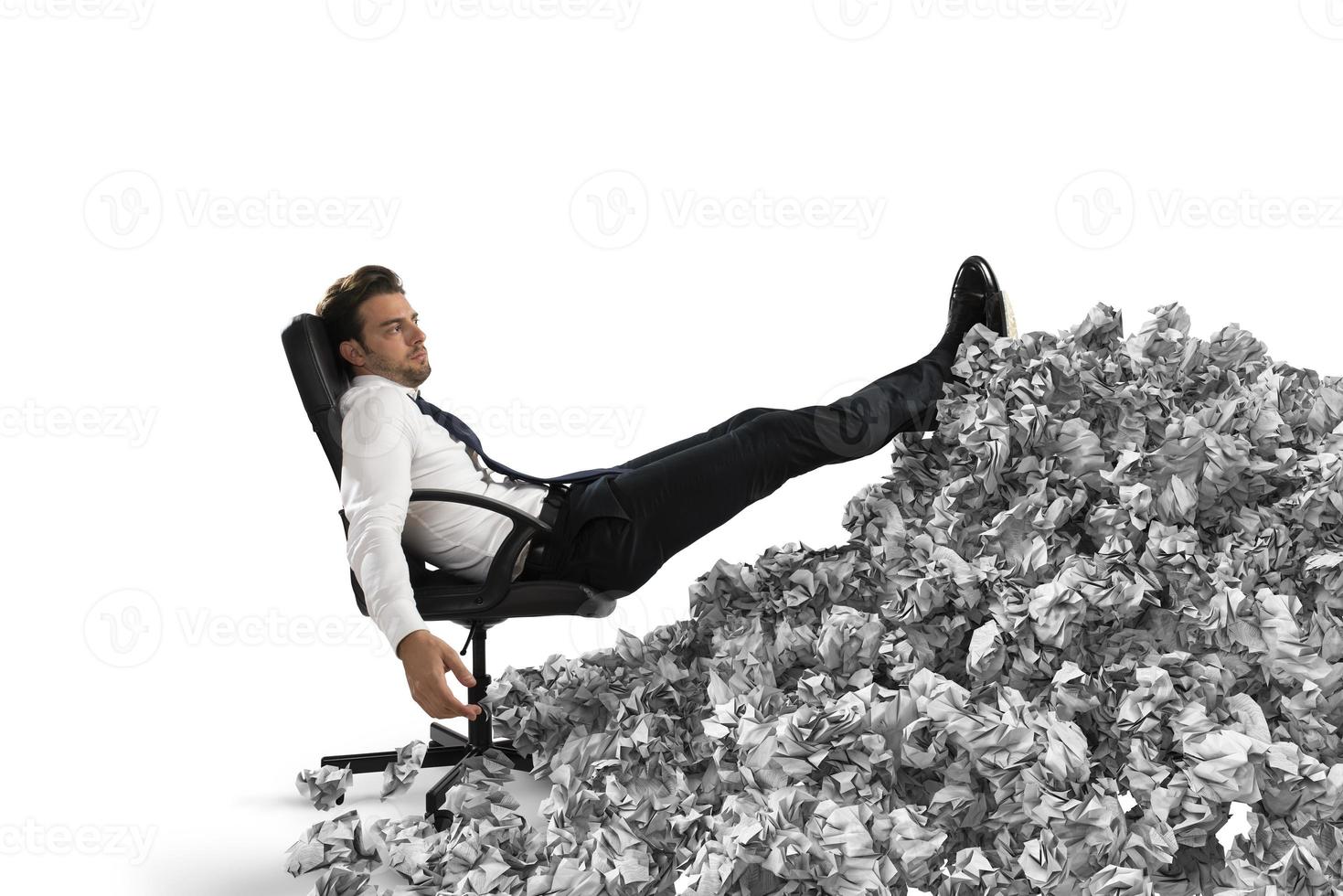 Businessman with paper sheet anywhere. Buried by bureaucracy. Concept of overwork photo