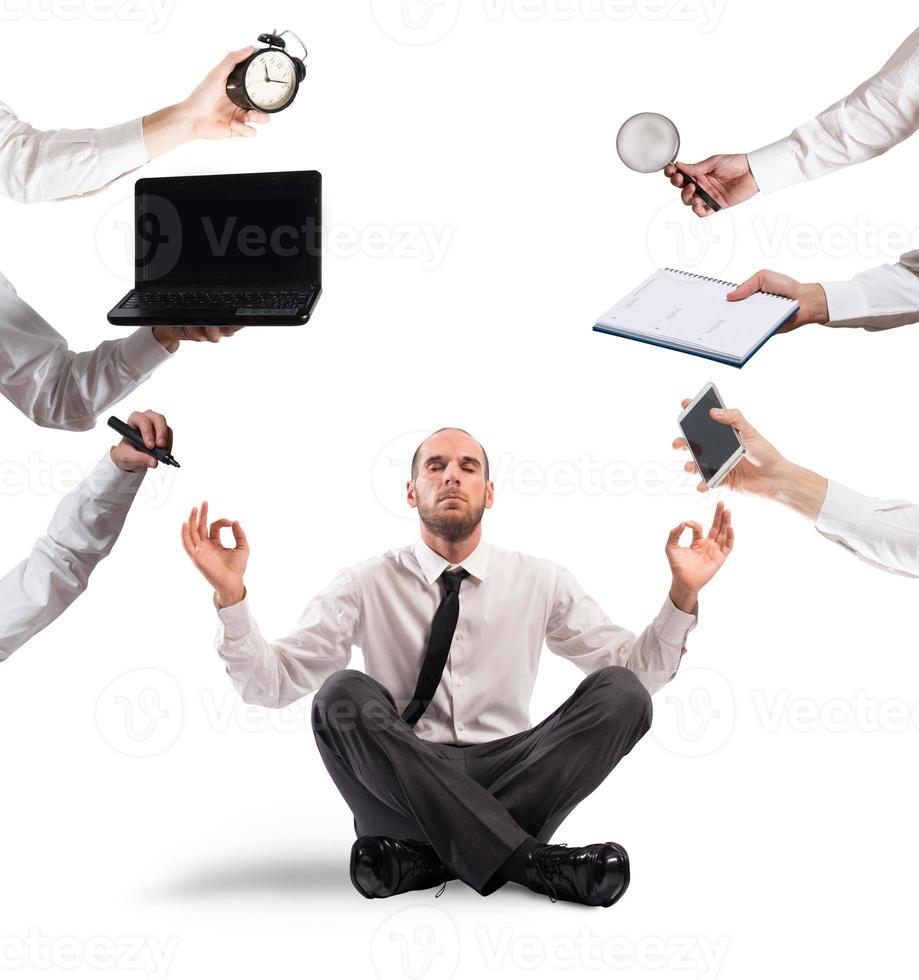 Relaxed businessman that does yoga during the work photo