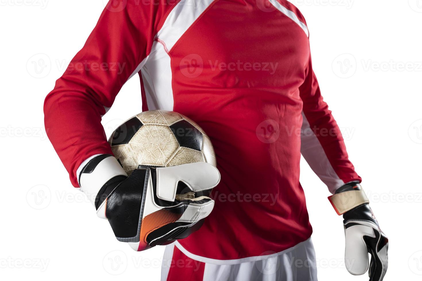 Goalkeeper holds the ball in the stadium during a football game. Isolated on white background photo