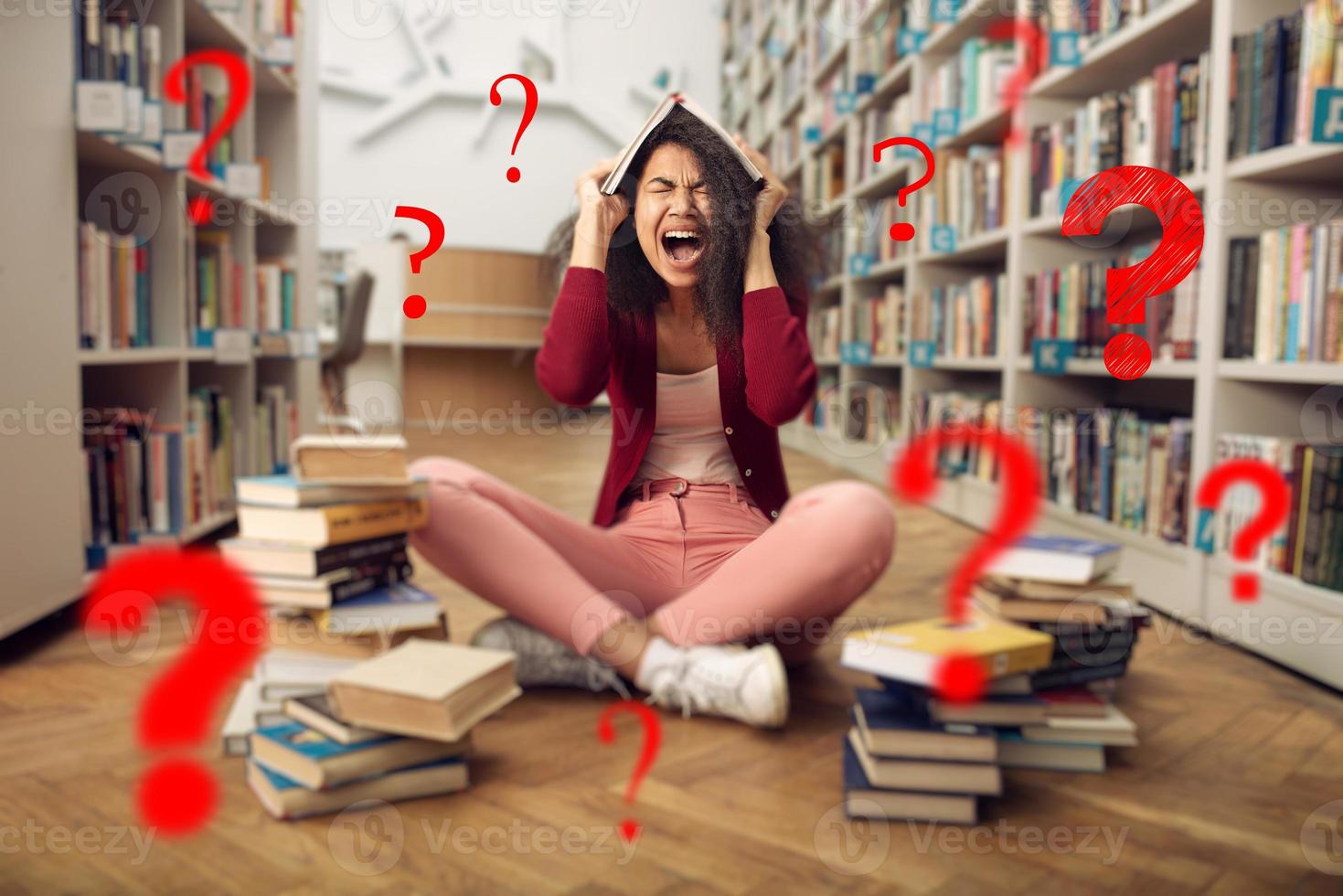 Tired university student has difficulty to study. Concept of stress, question and difficulty photo