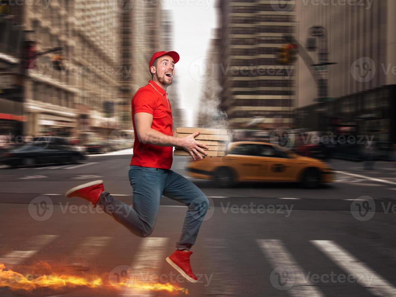 Messenger in red uniform runs on foot really fast to deliver quickly hot pizzas just baked photo