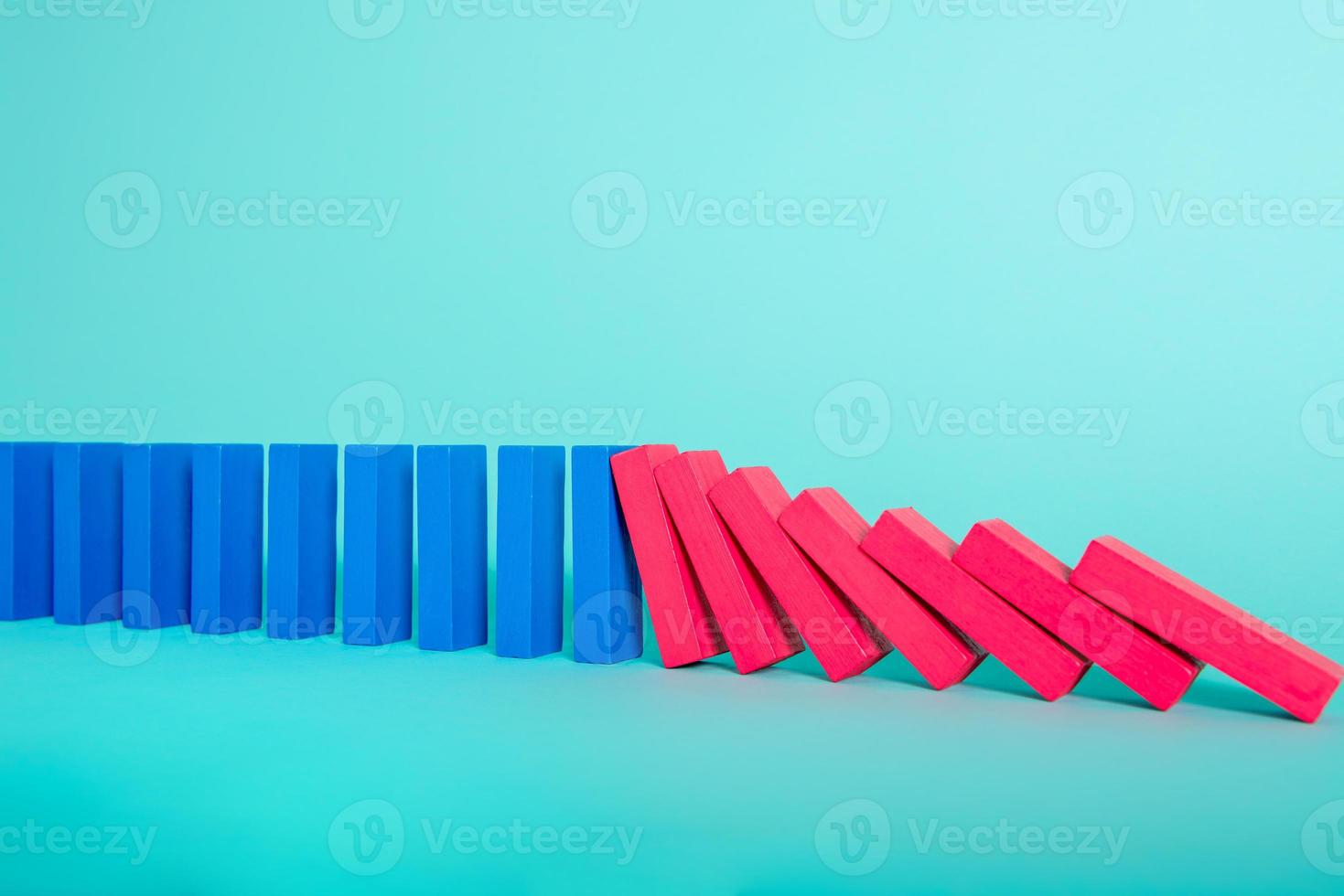 Concept of covid19 coronavirus pandemic with falling chain like a domino game. Contagion and infection progression. Cyan background photo