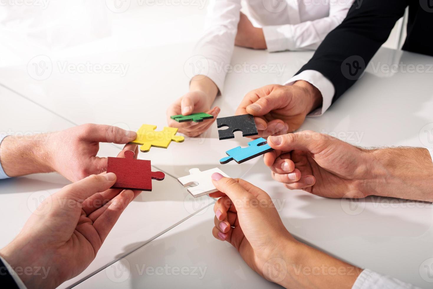 Teamwork of partners. Concept of integration and startup with puzzle pieces photo