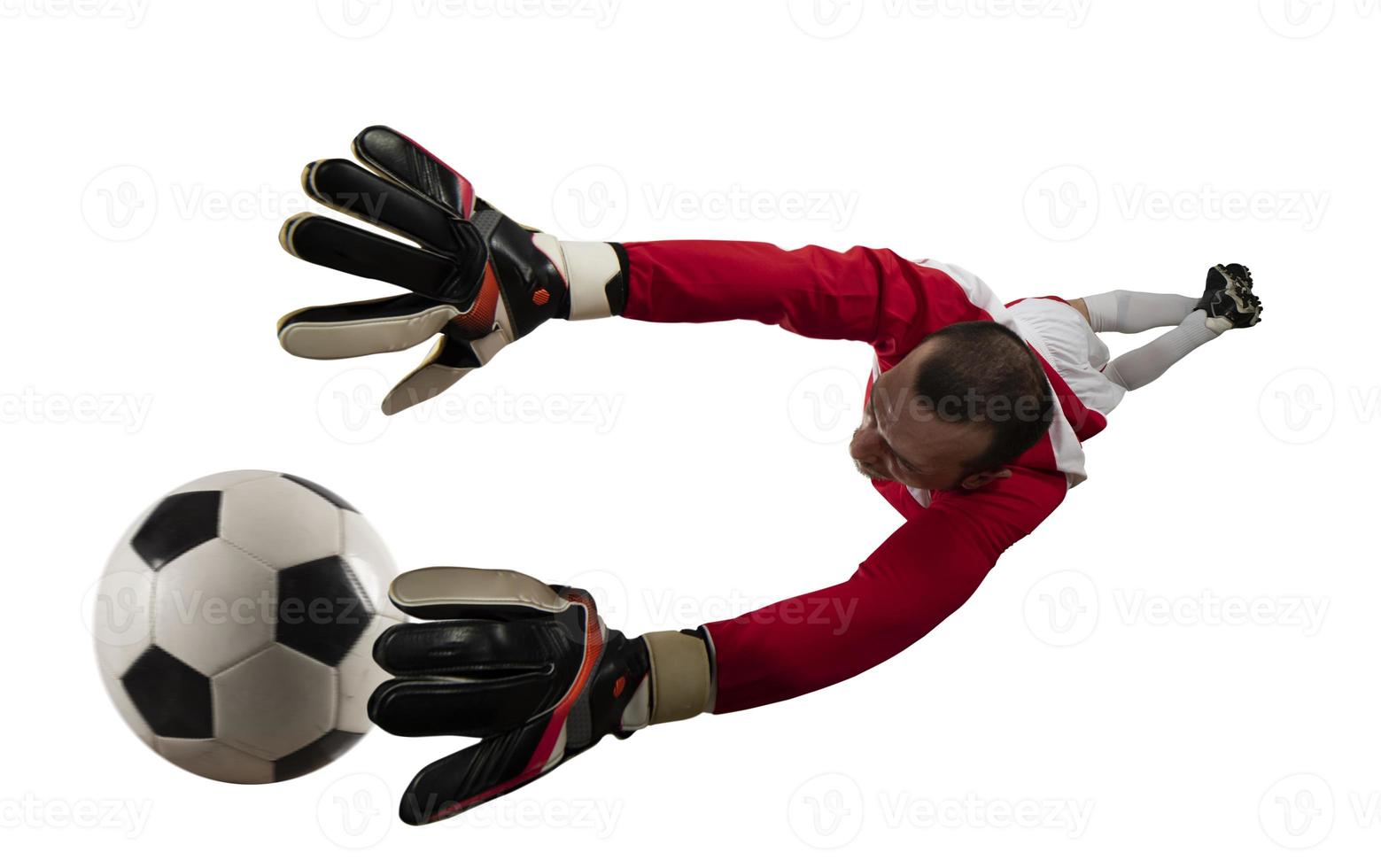 Goalkeeper tries to tatches the ball. Isolated on white background photo