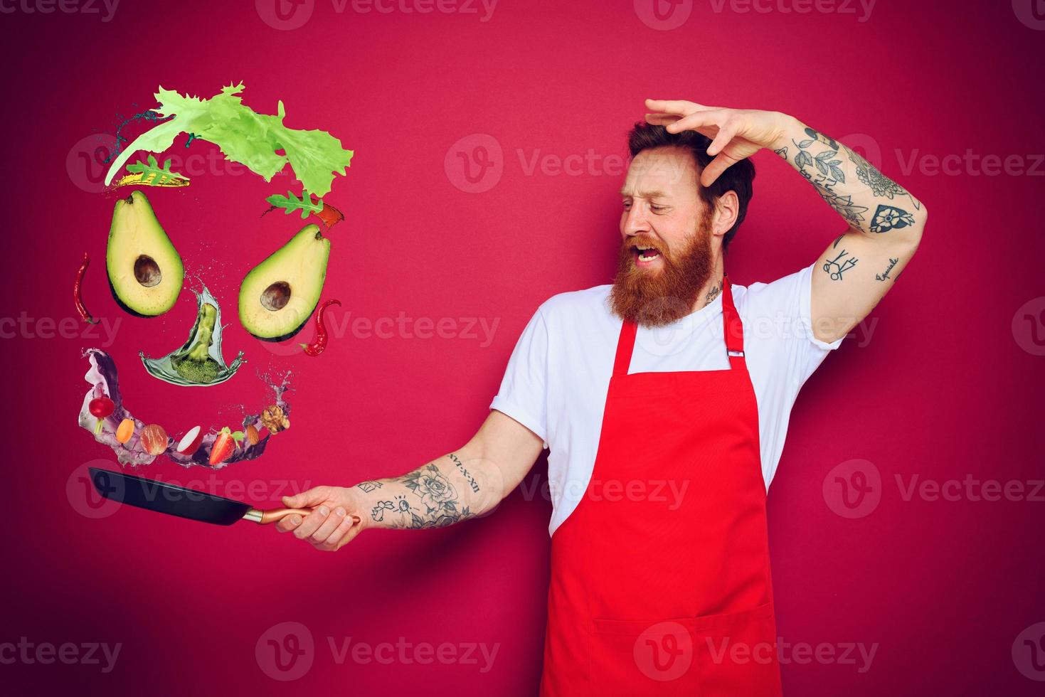 Man chef with pan in hand acts like a sorcerer photo