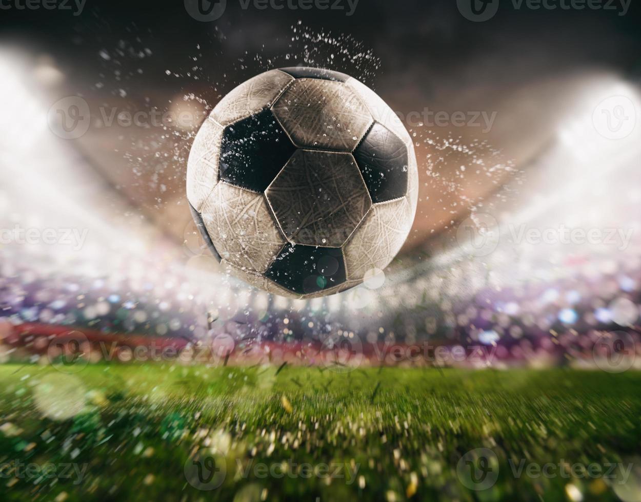 Close up of a soccer ball kicked with power at the stadium photo