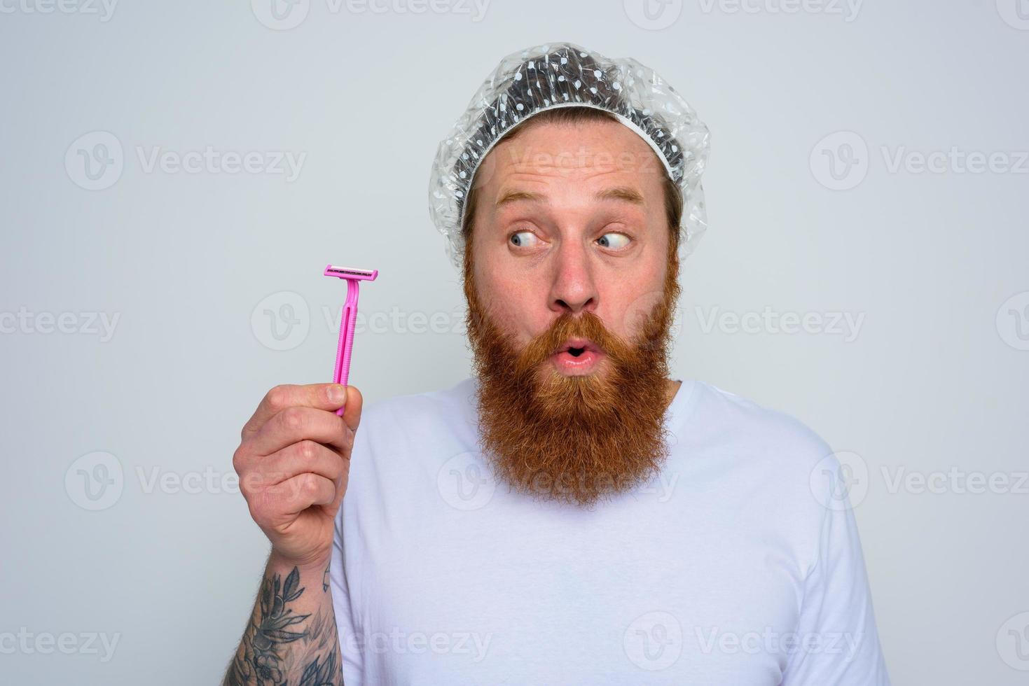wondered man adjust the beard with a razor blade photo