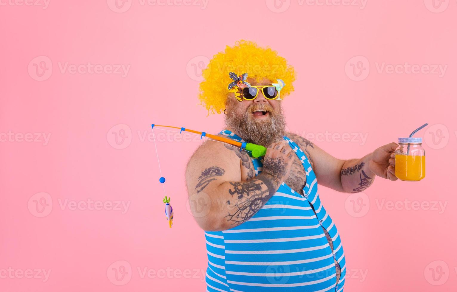 Fat happy man with beard and sunglasses have fun with the fishing pole photo