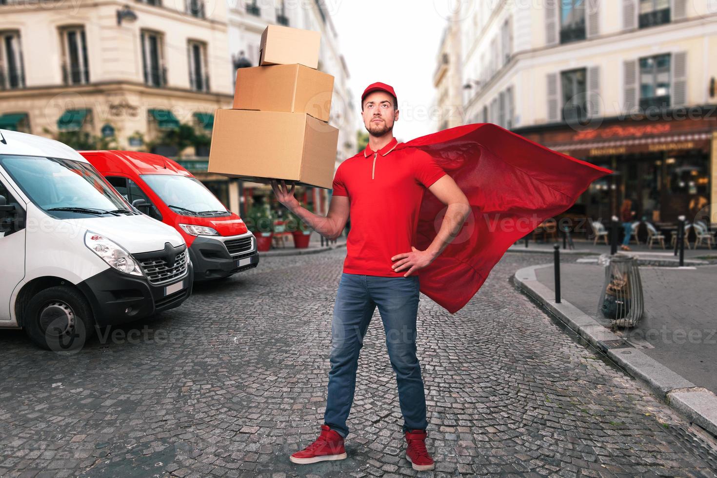 Superhero man with red uniform in front of the shops for delivery and pickup of the goods photo