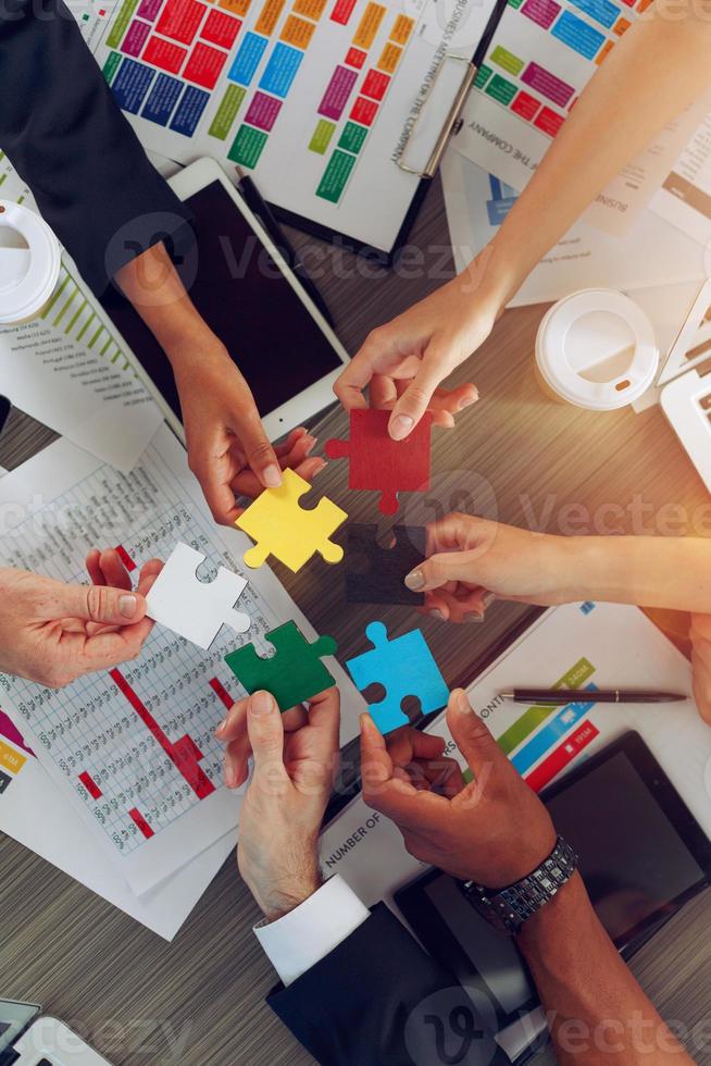 Teamwork of partners connect puzzle pieces as integration and startup photo