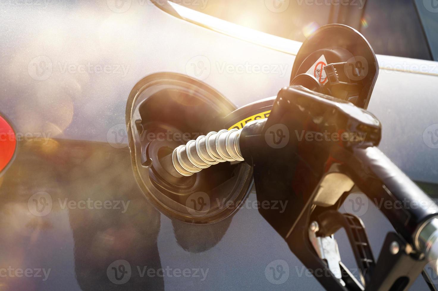 Fuel pump fill a tank of a car in a station photo