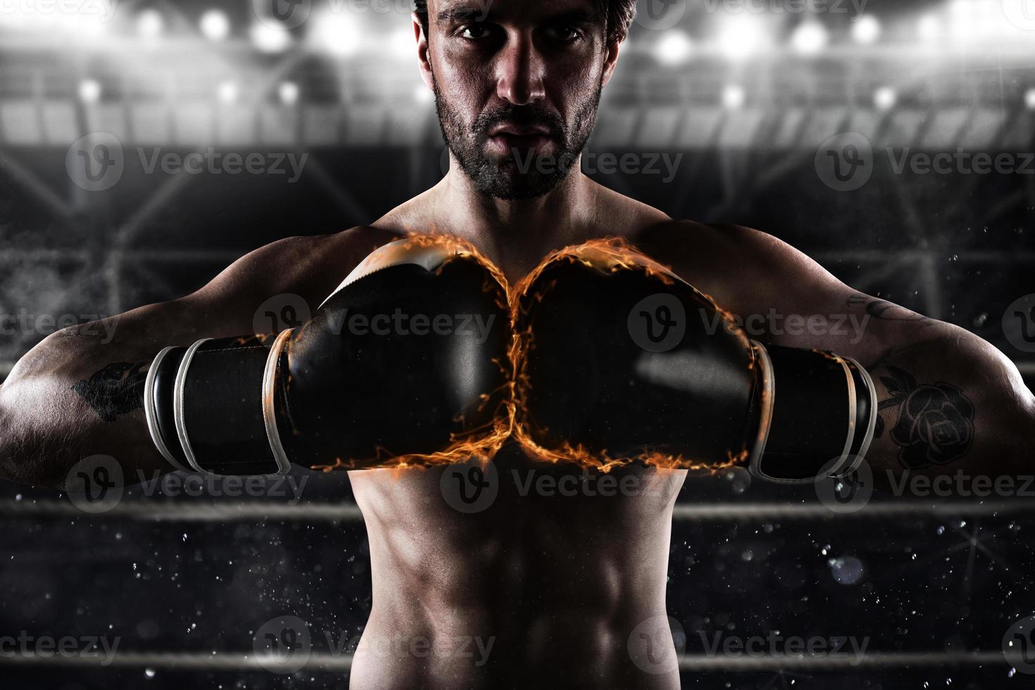 Confident boxer with fiery boxing gloves photo