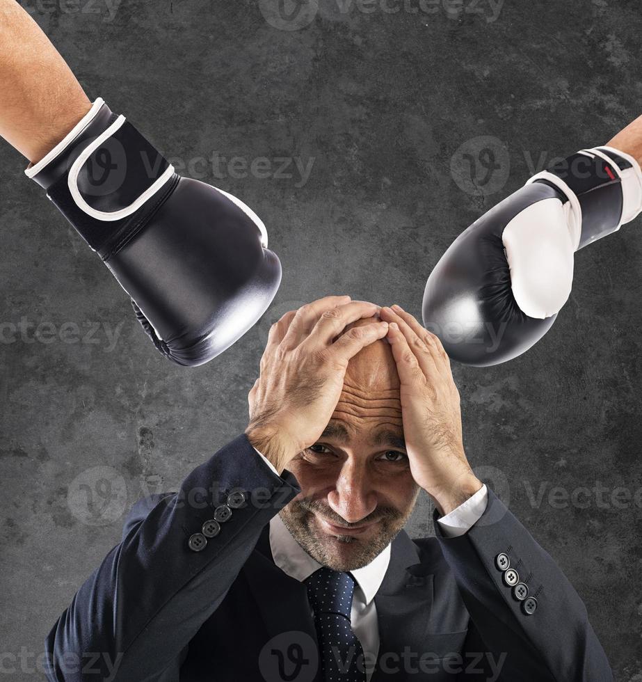 Businessman receives fists from competitors. concept of difficult career photo