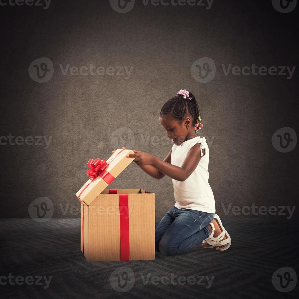 Happy little girl with a Christmas gift photo