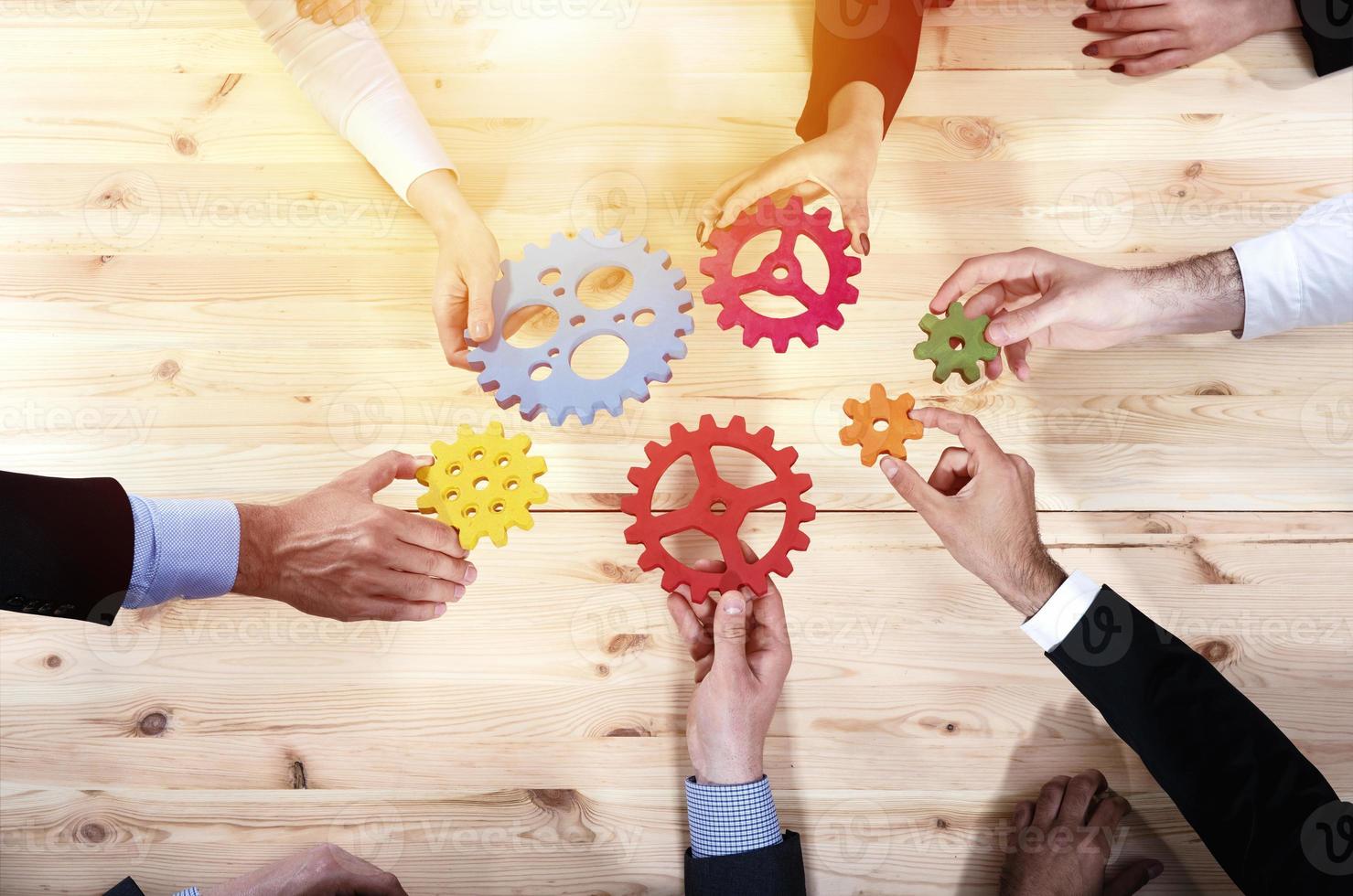 Business team connect pieces of gears. Teamwork, partnership and integration concept photo
