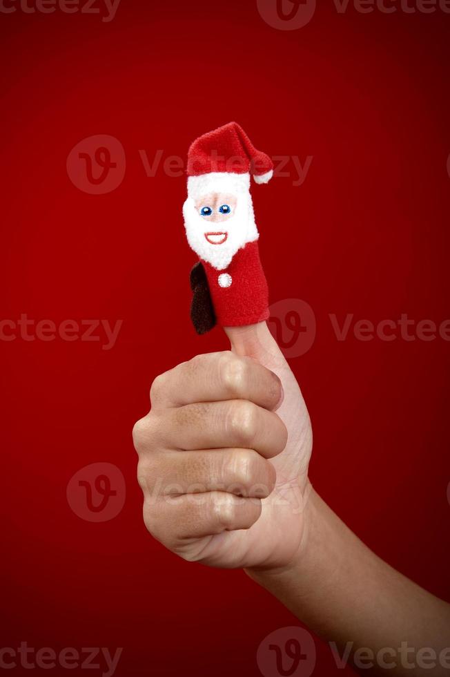 Christmas finger puppet on red background photo