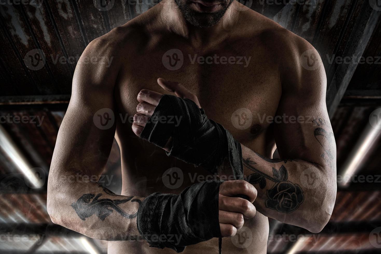 Boxer puts the tapes to his hands photo