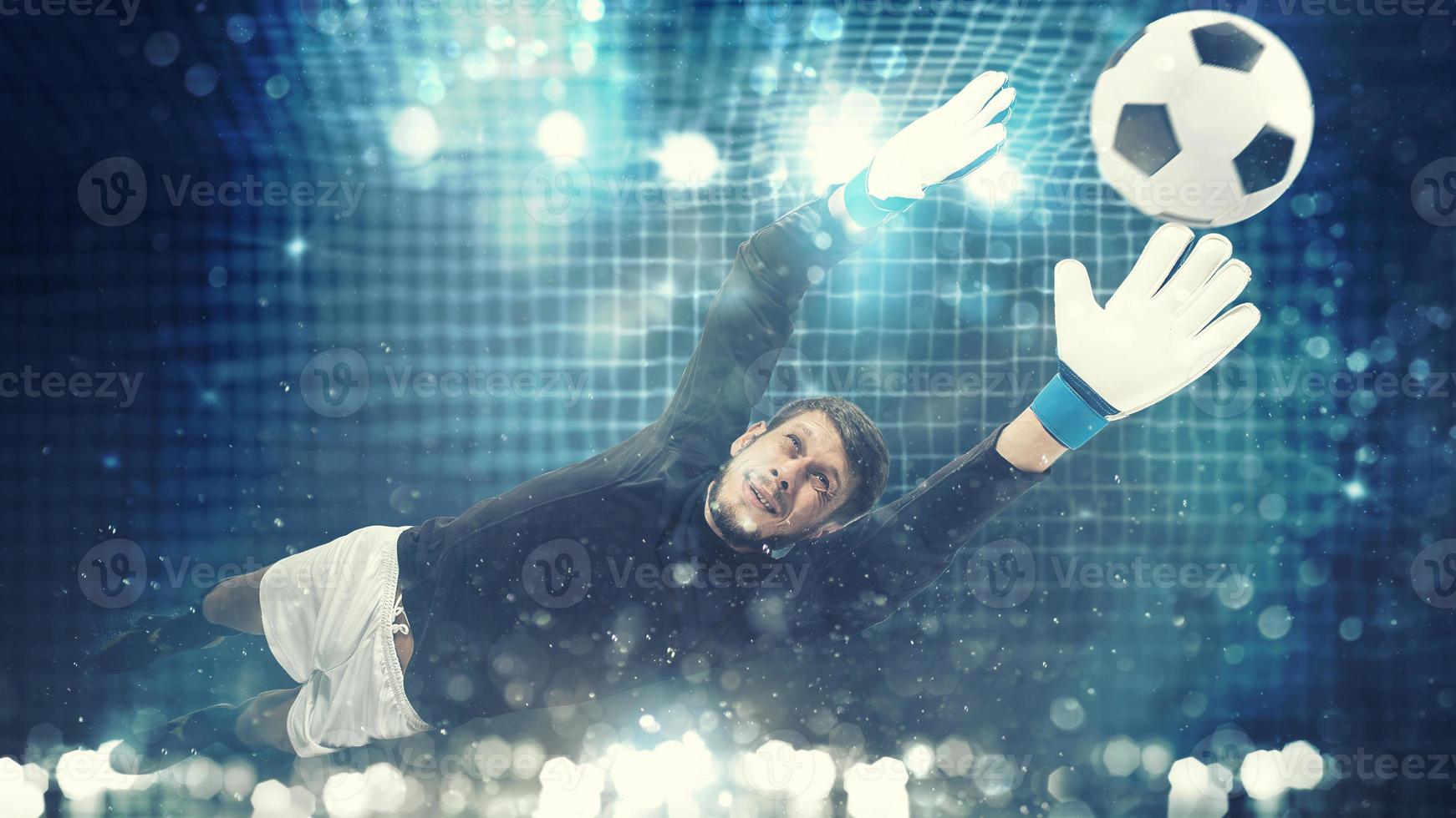 Close up of a goalkeeper dives to save a shot aimed at the goal with light effects photo