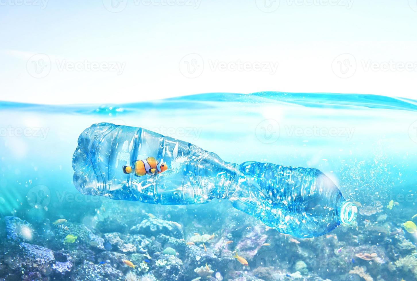 Fish trapped inside a bottle. Problem of plastic pollution under the sea concept. photo