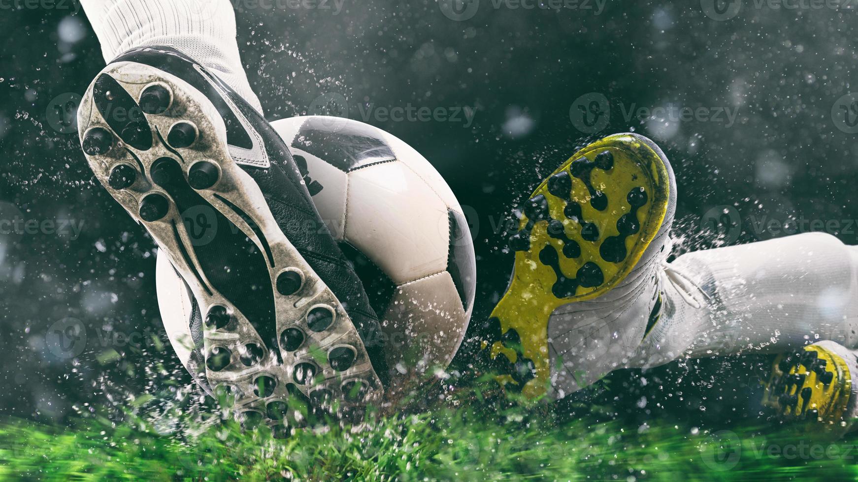 Football scene at night match with close up of a soccer shoe hitting the ball with power photo