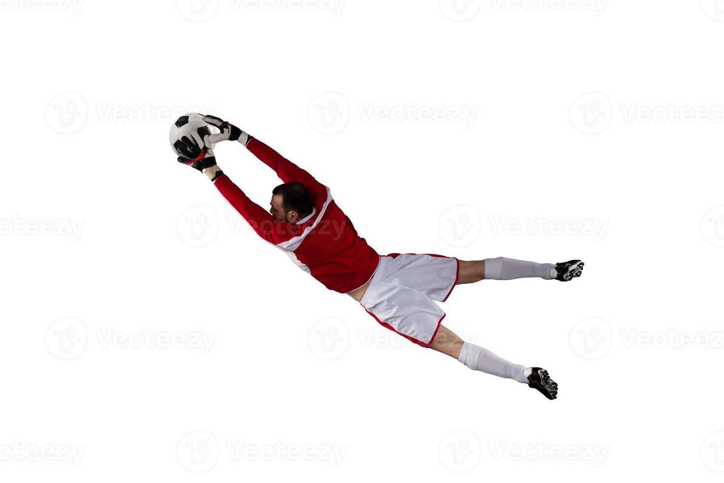 Goalkeeper catches the ball in the stadium. Isolated on white background photo