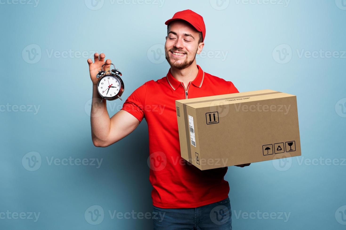 Courier is punctual to deliver the package. Emotional expression. Cyan background photo