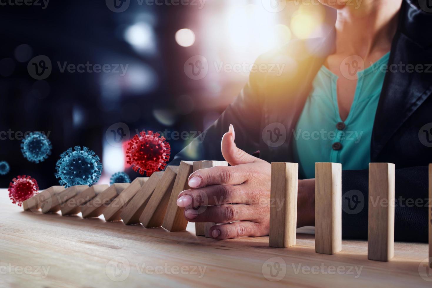 Businesswoman stops a chain fall by viruses like domino game. Concept of preventing crisis and failure in business. photo