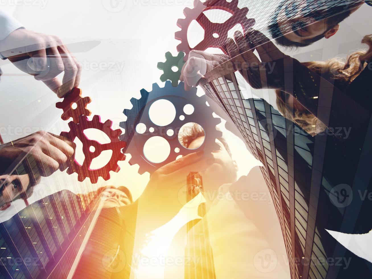 Business team connect pieces of gears. Teamwork, partnership and integration concept. double exposure photo