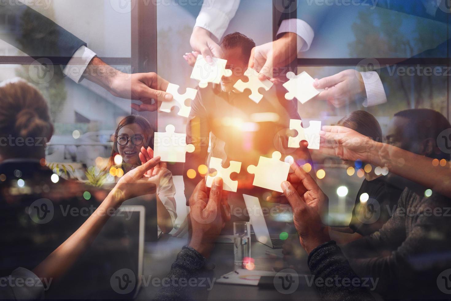 Teamwork of partners. Concept of integration and startup with puzzle pieces. Double exposure photo