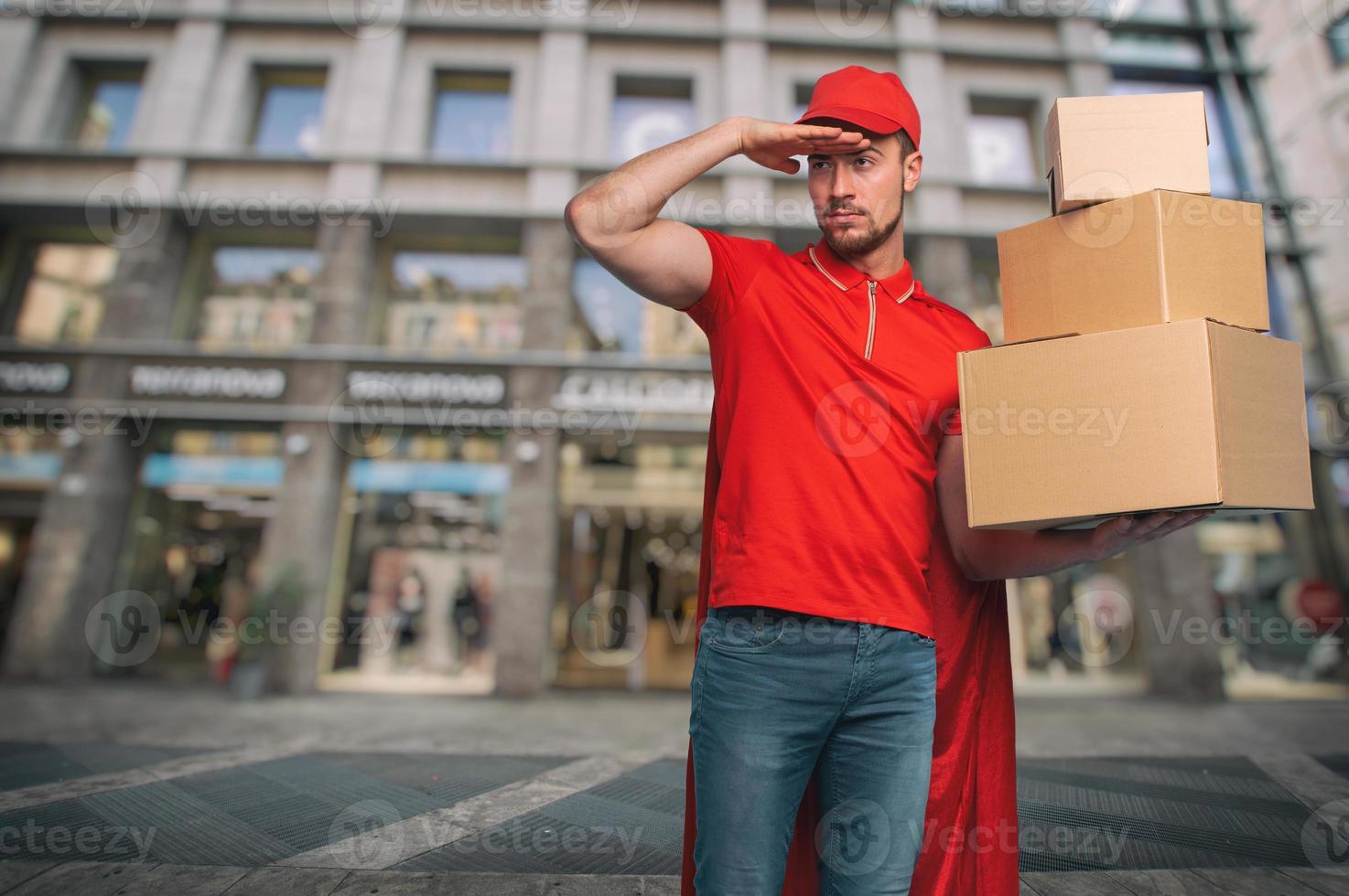 Red courier acts like a powerful superhero. Concept of success and guarantee on shipment. photo