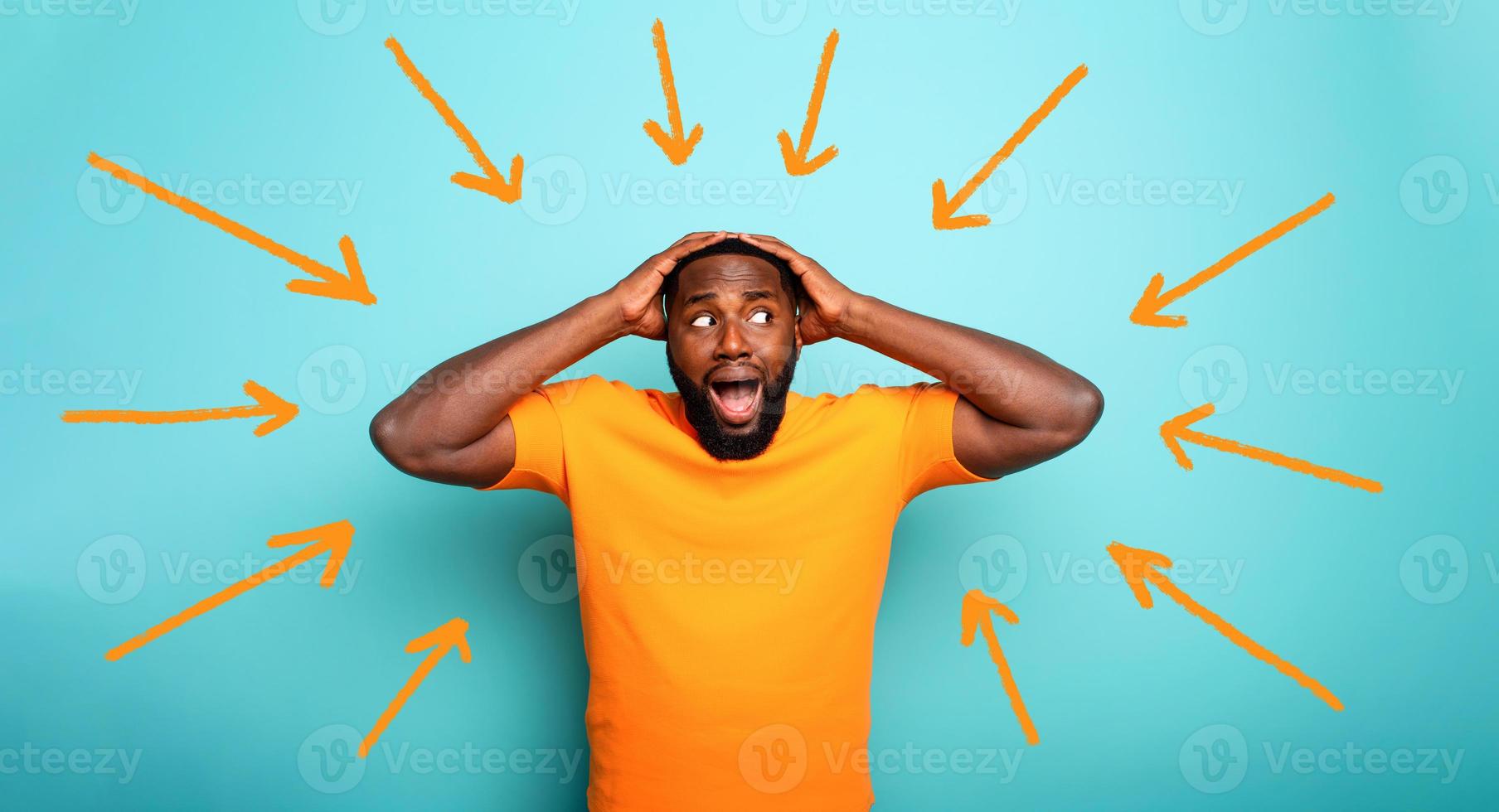 Feared, confused and shocked expression of a boy followed by arrows. cyan colored background photo