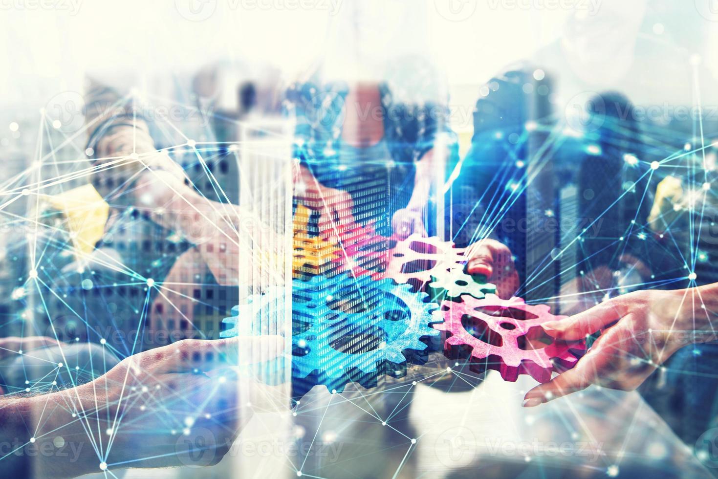 Working group of businessmen find the agreement by holding a piece of gear in hand. concept of teamwork and business partnership. double exposure with network effects photo