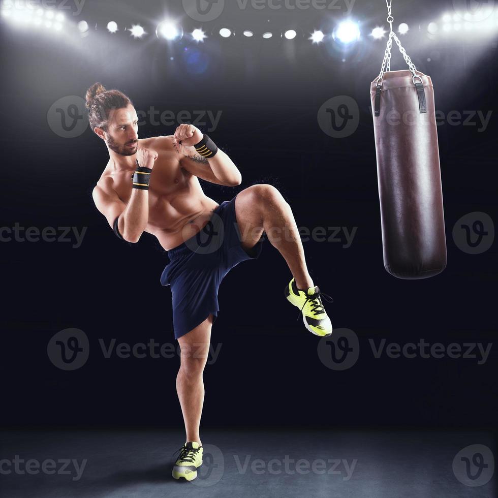 Man is training with the punching bag photo