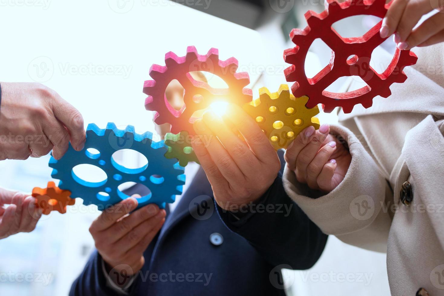 Business team connect pieces of gears. Teamwork, partnership and integration concept photo