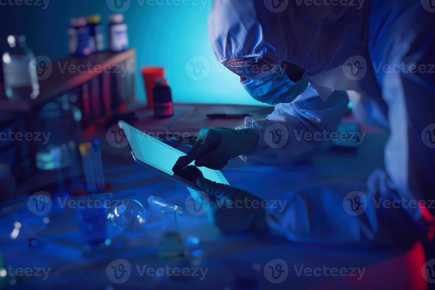 Man with tablet in a medical science laboratory. Concept of virus and bacteria research photo