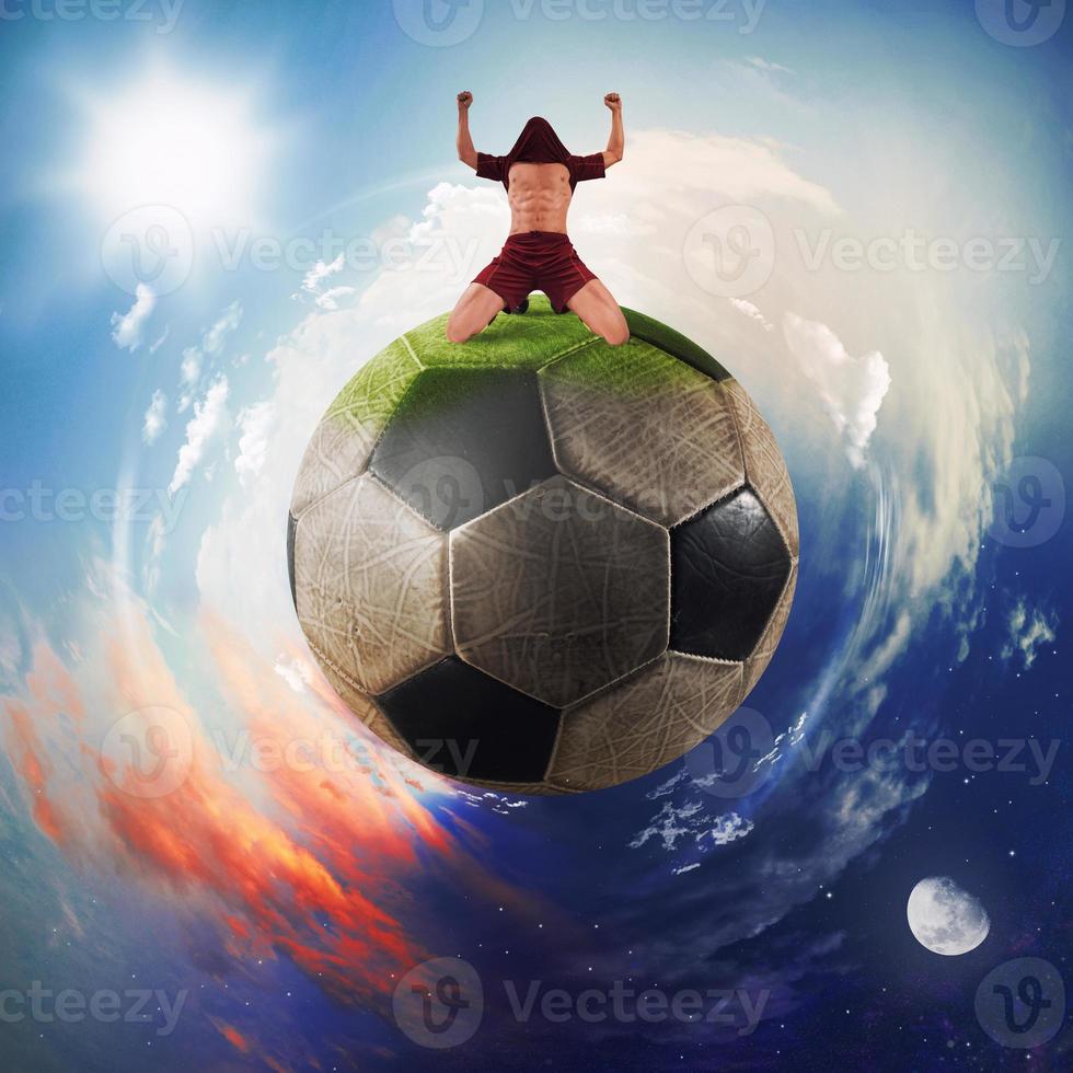 Football player exults in a soccer ball planet photo