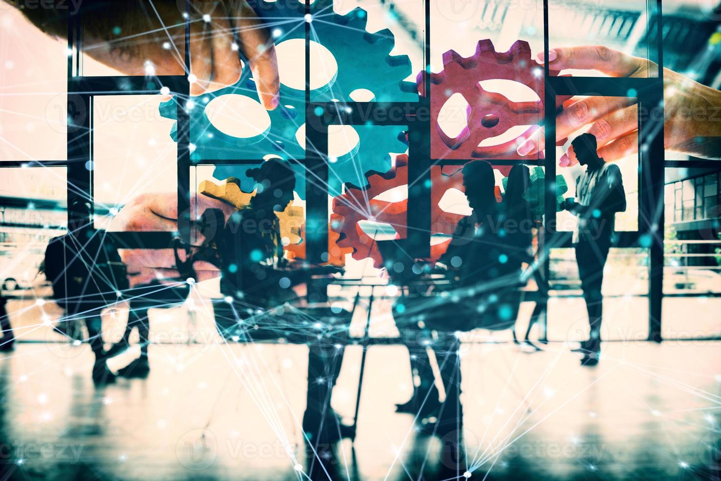 Business team connect pieces of gears. Teamwork, partnership and integration concept. double exposure with network effects photo